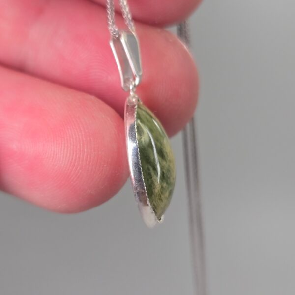 Pendant, silver, pounamu, flower jade, taonga. (7) Pendant, silver, pounamu, flower jade, taonga. (7)