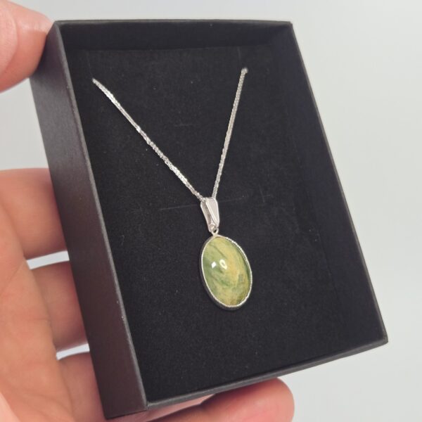 Pendant, silver, pounamu, flower jade, taonga. (9) Pendant, silver, pounamu, flower jade, taonga. (9)